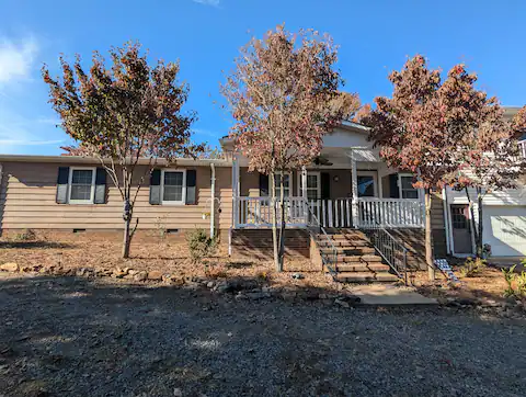 Front of the house with gravel circle driveway.