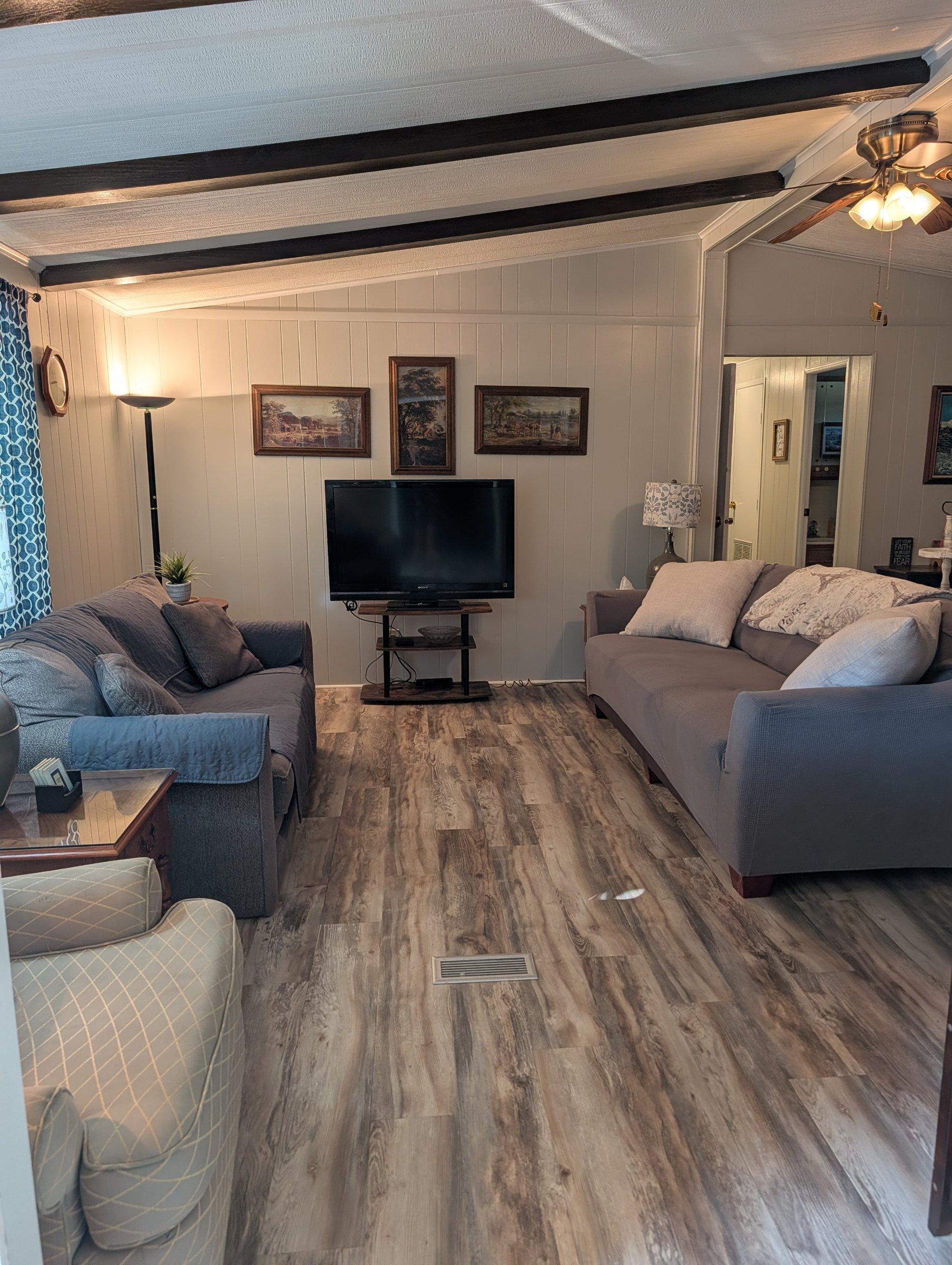 Living room with one oversized couch, a regular couch, and an additional chair.